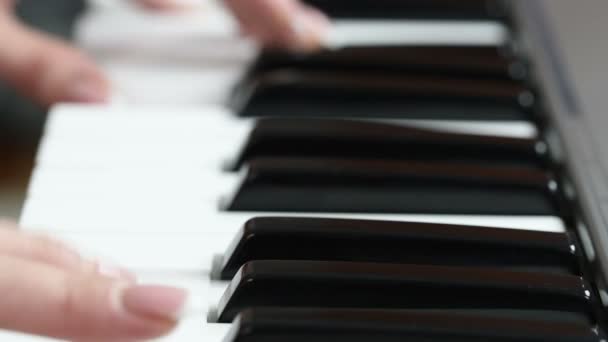 Mani di una giovane donna che suona il pianoforte — Video Stock