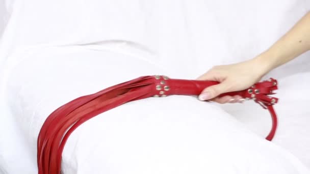 Girl takes a red leather whip. sex toys. — Stock Video