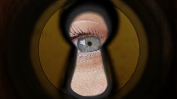 Woman eye watching through keyhole — Stock Video