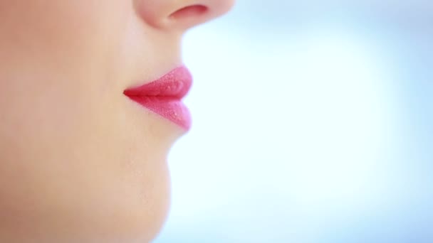 Close up of young woman lips over blue — Stock Video