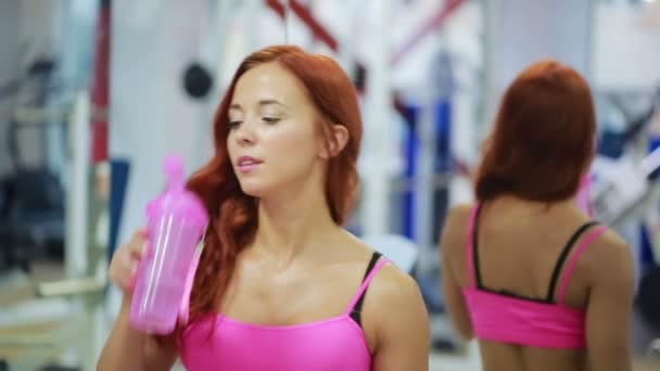 Sportive female thirsty after active workout, drinking fresh water — Stock Video