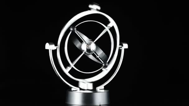 Close up of Newtons Cradle, Desk toy pendulum being activated, black background — Stock Video