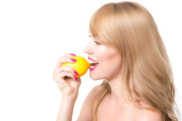 Girl biting a lemon Stock Picture