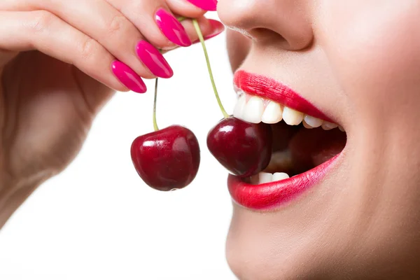 Girls lips and tongue licking two berries Stock Image