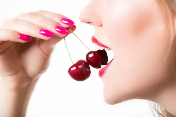 Girls lips and tongue licking two berries Royalty Free Stock Images
