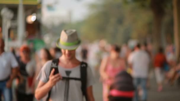 Hombre usando un teléfono móvil en la calle. un hombre guapo en un sombrero con smatrtfonom — Vídeo de stock