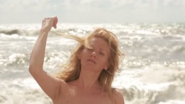 kameraya gülümseyen plajda sarışın kız