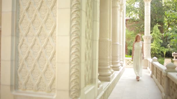 Beautiful girl walking on the Arabic palace. tourism concept. white lace dress — Stock Video