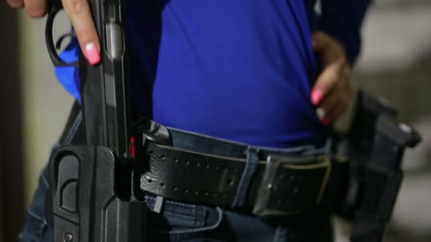 Junge Frau mit der Waffe auf einem Indoor-Schießstand. Gewehr einsammeln — Stockvideo