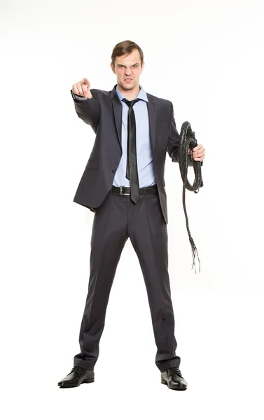 Business woman with a whip in her hands. — Stock Photo, Image