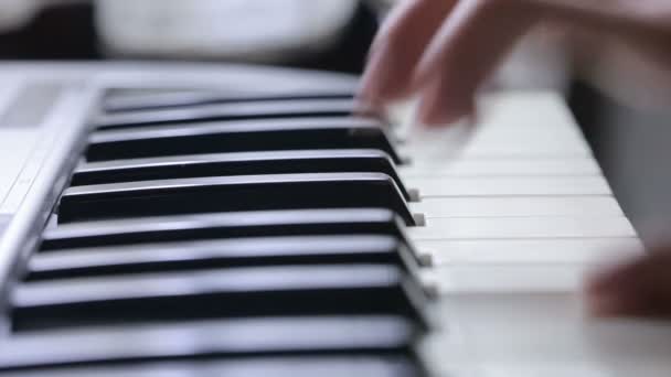 Woman hand playing a MIDI controller keyboard synthesizer close up. — Stock Video