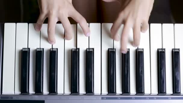 The hand on piano key in close-up shot. child learning to play the piano — Stock Video