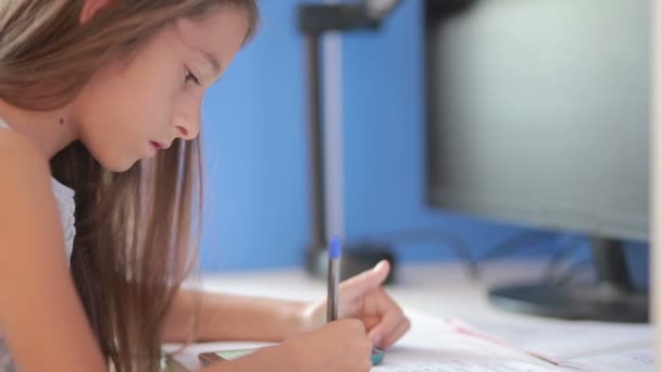 Gadis sekolah melakukan pekerjaan rumah di meja selebaran melalui buku. Gadis membuat pelajaran — Stok Video