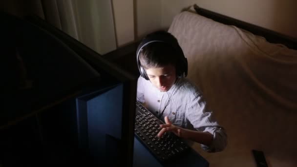 Teen boy plays games on the computer at night. Online Games — Stock Video