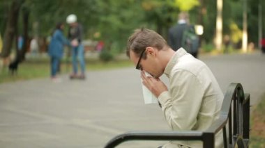 Young man holding handkerchief on nose. a man has a bad cold