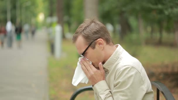 Young man holding handkerchief on nose. a man has a bad cold — Stok video