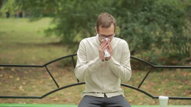 Young man holding handkerchief on nose. a man has a bad cold — 비디오