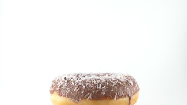 Female hand puts jewelry butt plug in chocolate donut. isolated white background — Stock videók