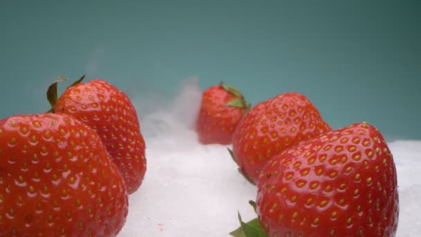 Extreme close-up, detailed. red strawberries lie on dry ice in smoke — Stock Video