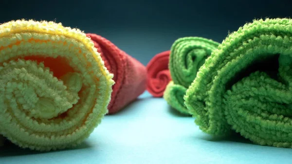 Extreme close-up, detailed. many multicolored cleaning rags on a blue background — Stock Photo, Image