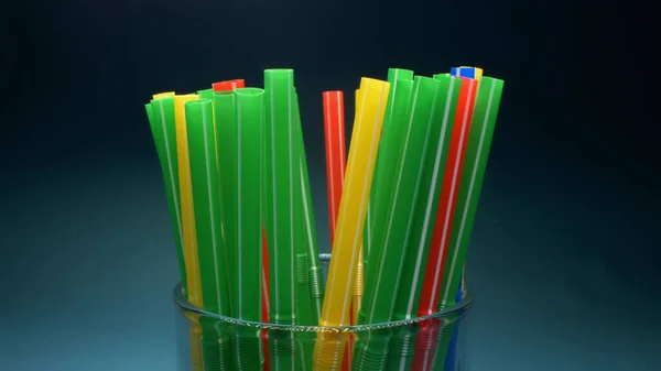 Extreme close-up, detailed. many multi colored cocktail straw. blue background. — Stock Photo, Image