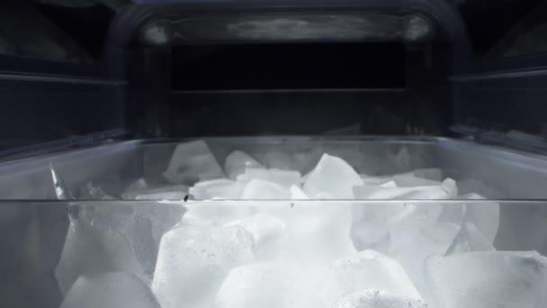 Extremadamente cerca, detallado. cubitos de hielo en un recipiente transparente de plástico — Vídeos de Stock