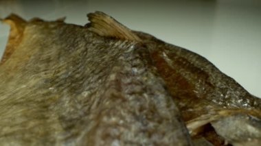 Son derece yakın plan, detaylı. Masada bir sürü kurutulmuş çipura var.