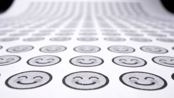 Background from smiles. icons with smiling faces on a sheet of paper. close-up — Stock Video