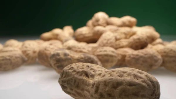 Extremely close-up, detailed. peanuts in shells on a dark background — Stock Photo, Image