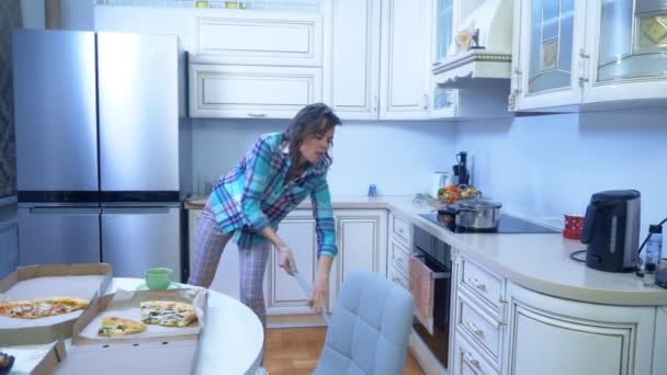 Vidám nő felmossa a padlót a konyhában otthon, és táncol — Stock videók
