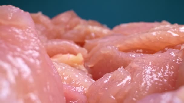 Extremely close-up, detailed. sliced chicken fillet on a blue background — Stock Video