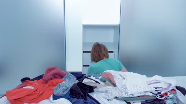Woman doing cleaning at home wiping dust in the closet with a red rag — Stock Video