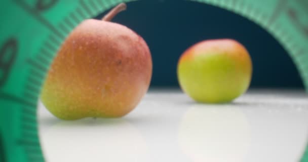 Detailed extreme close-up of measuring tape and apples — Stock Video