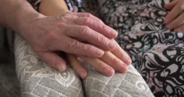 Yaşlı bir çiftin evdeki sandalyesine yakın plan çekimleri.