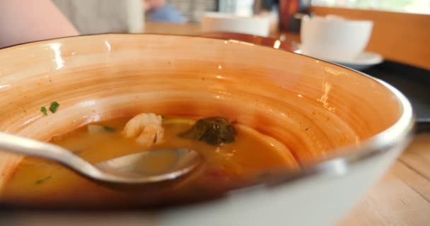 Alguien come con una cuchara de sopa de ñame Tom de un plato. primer plano — Vídeos de Stock