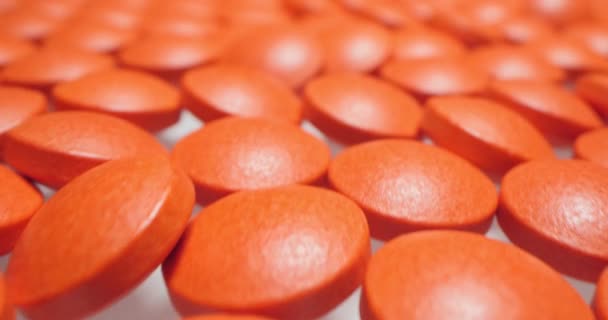 Orvosi háttér. részletes közelkép piros kerek tabletták fehér felületen — Stock videók