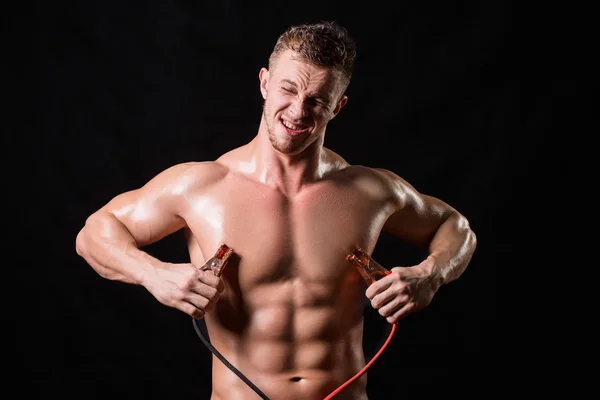 Athlete holds the high voltage wires. — Stock Photo, Image