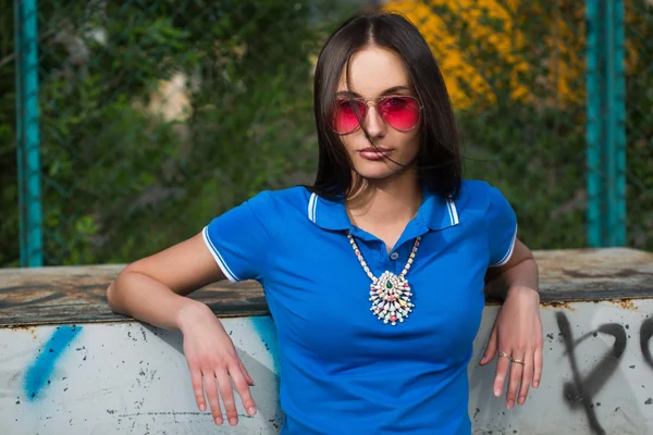 Sexy girl in pink glasses and a necklace — Stock Photo, Image