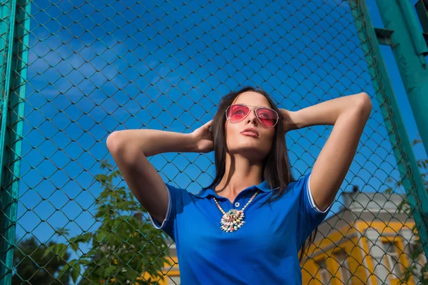 Sexy girl in pink glasses and a necklace — Stock Photo, Image