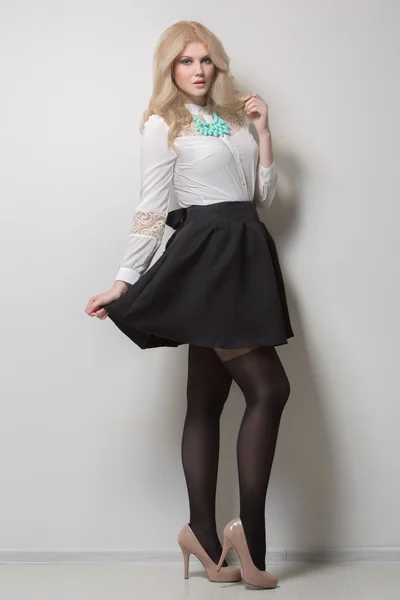 Beautiful blonde with long hair in a skirt. thick. — Stock Photo, Image