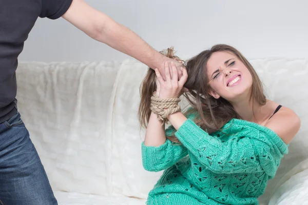 Man hitting a young woman.  hands are tied — Stock Photo, Image