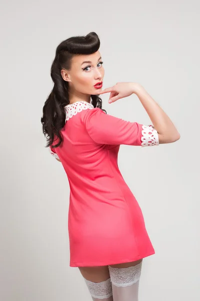 Emotional sexy pin-up girl in coral dress — Stock Photo, Image