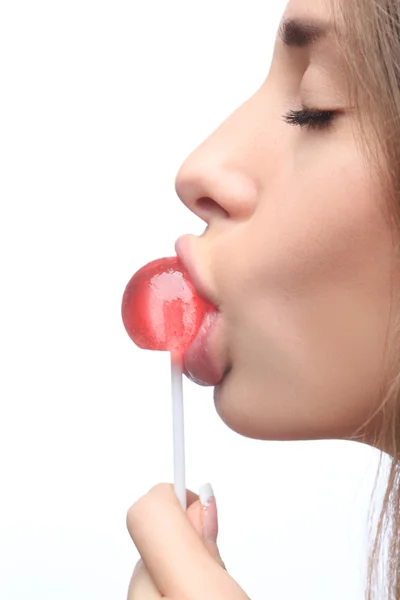 Closeup girl sucks a lollipop. — Stock Photo, Image