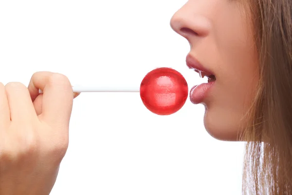 Closeup girl sucks a lollipop. — Stock Photo, Image