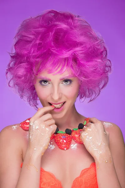 Menina com cabelo rosa. um colar de doces — Fotografia de Stock