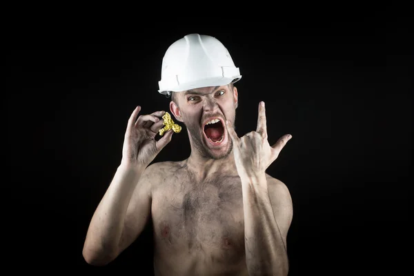 Happy  miner shows a golden nugget — Stock Photo, Image