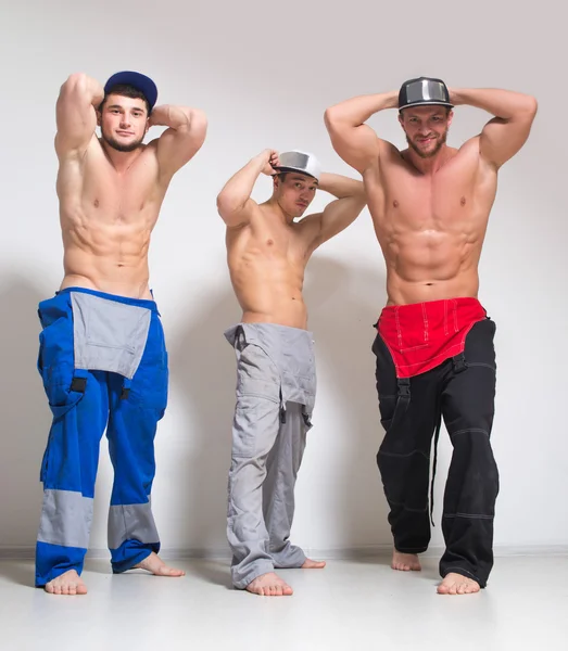 Üç seksi adam iş yarı tulumlar içinde — Stok fotoğraf