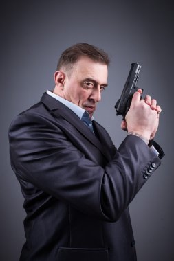 man in a business suit with a gun clipart