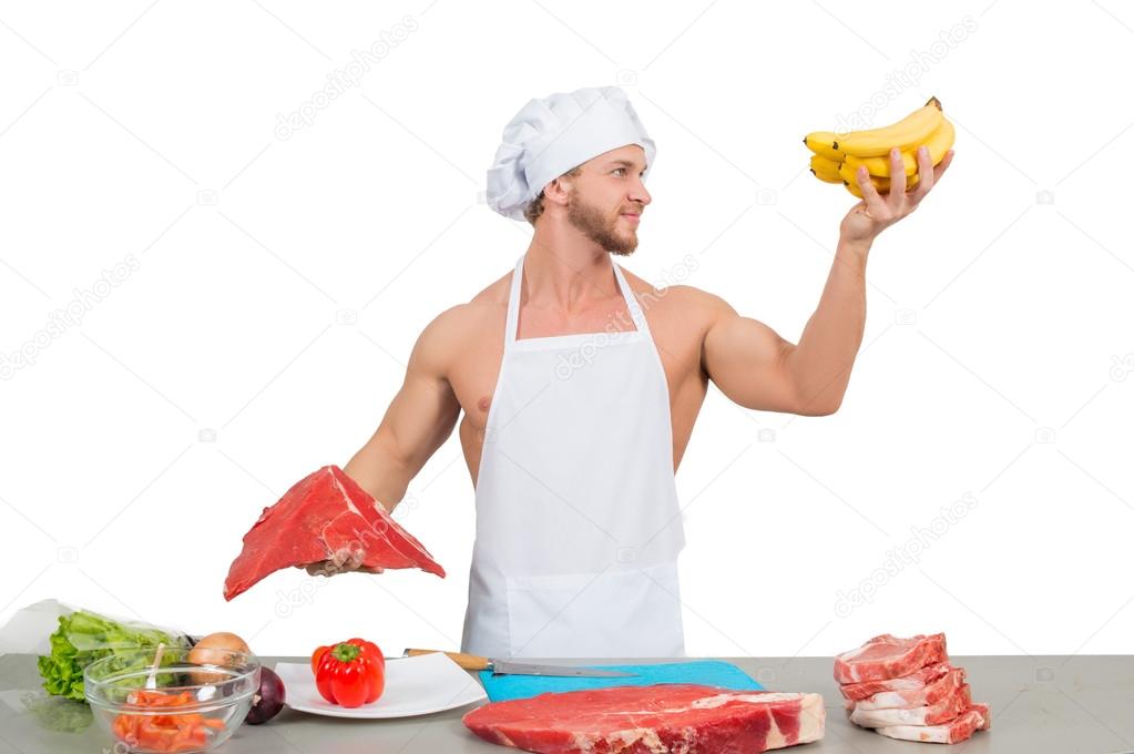 chef in a white apron holding meat and bananas