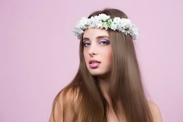 Young model with bright flowers on her head — Stock Photo, Image